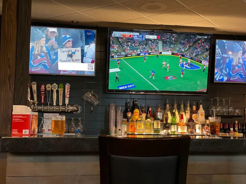 The bar, with beer taps and the game on the TVs