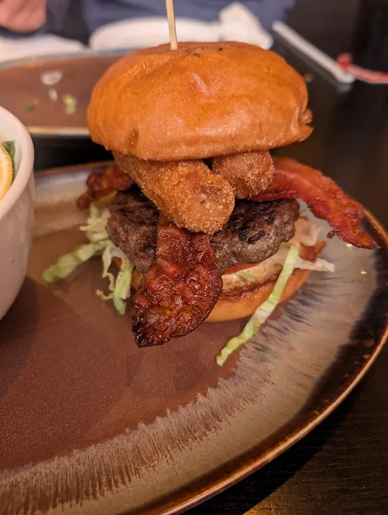 Barrydowne Bomb burger with a bacon-wrapped onion ring